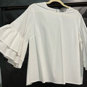 White top with trumpet ruffle sleeves